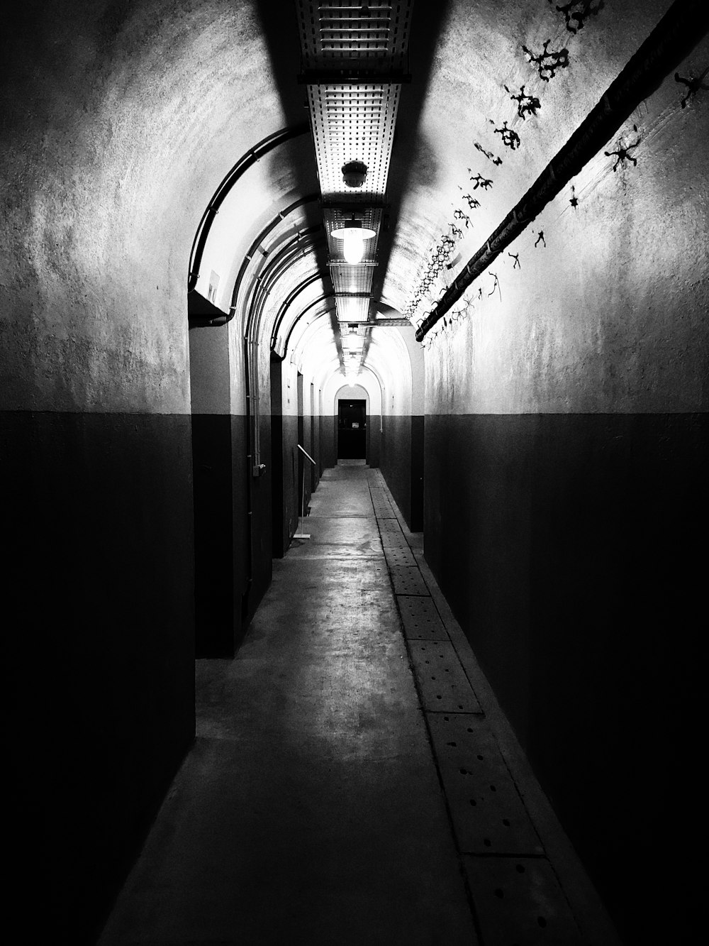 a long hallway with a light at the end of it