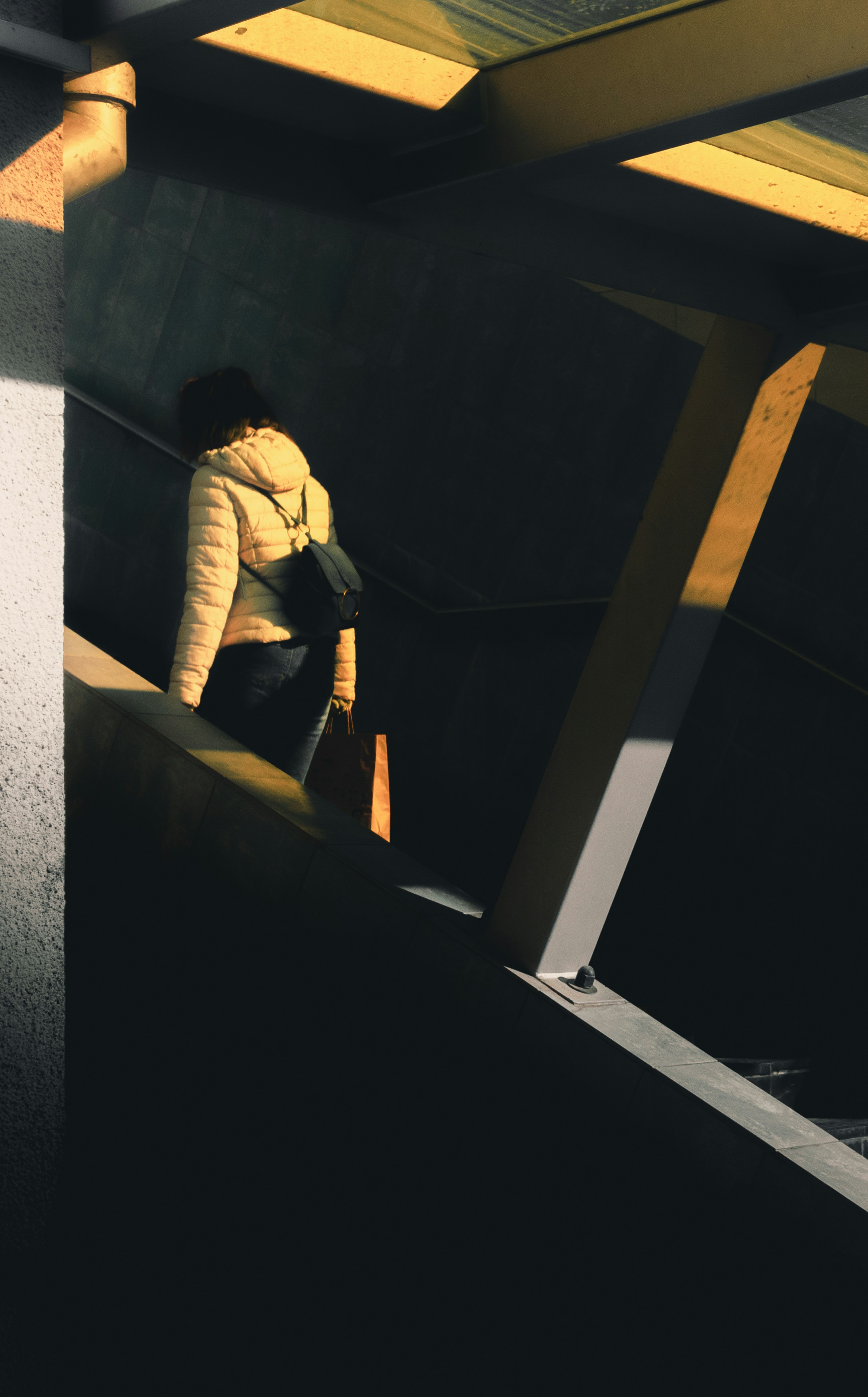 a person sitting on a ledge in a building