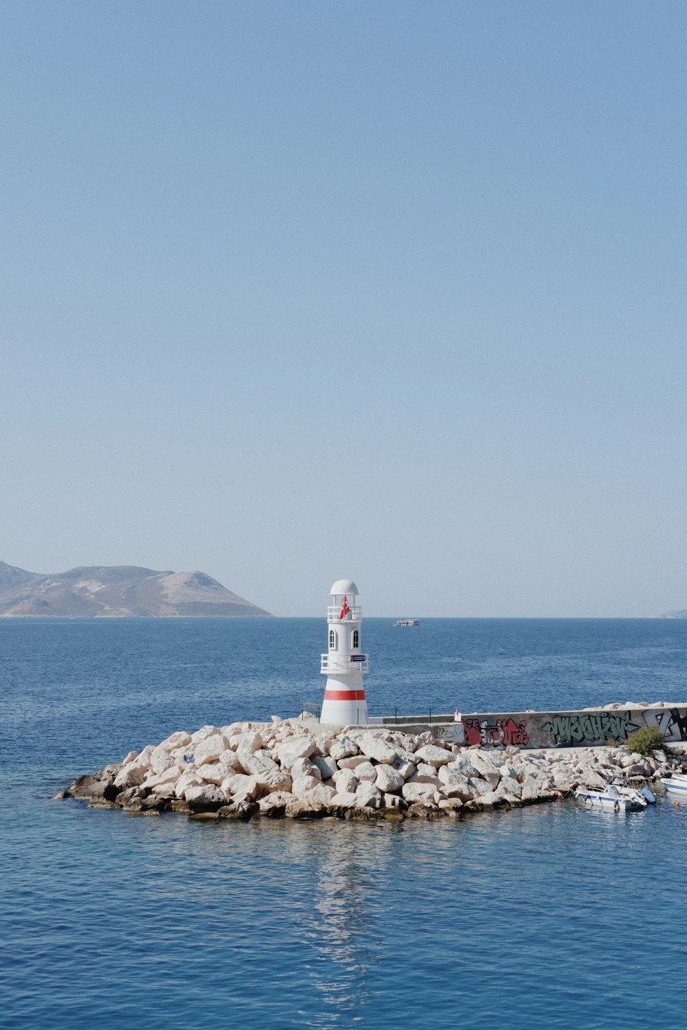 a light house sitting on top of a small island