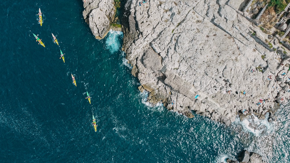 a group of people riding on top of a boat in the ocean