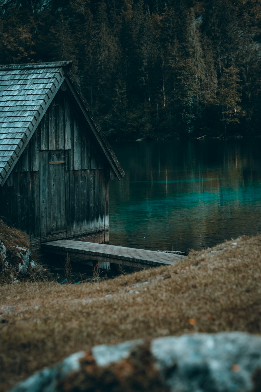 a small wooden cabin sitting on top of a lake