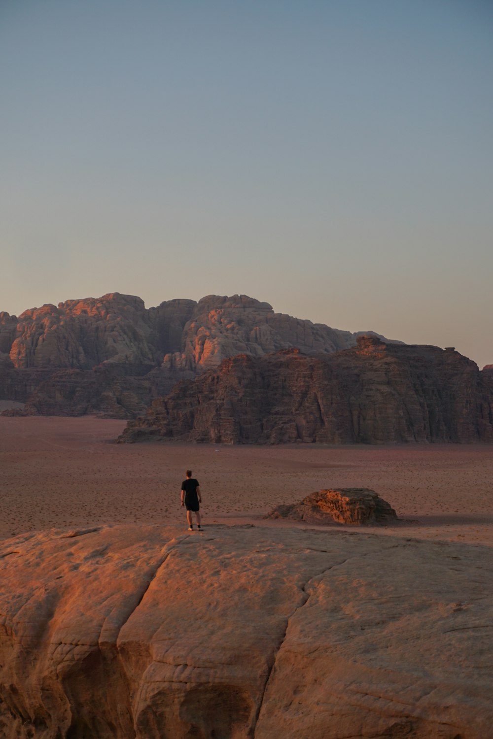 a person standing on top of a large rock