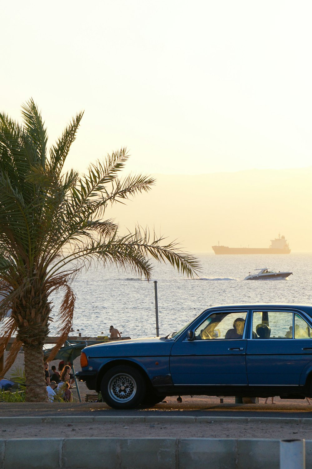 a blue car parked on the side of the road