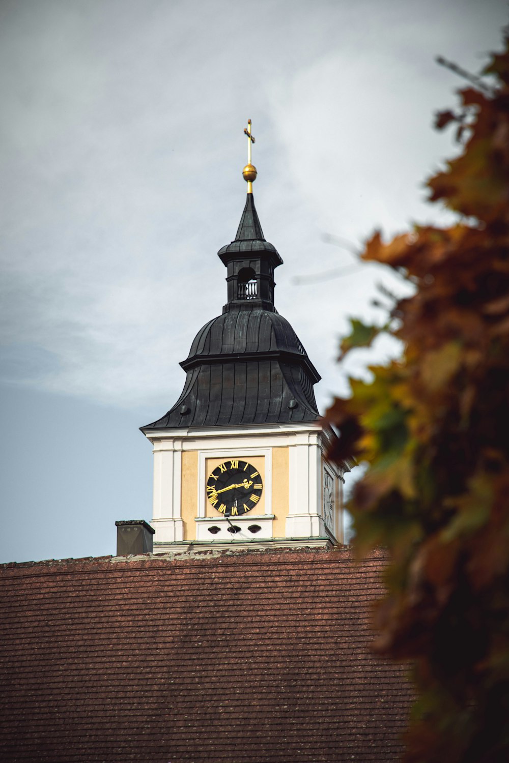 a clock tower on top of a building with a sky background