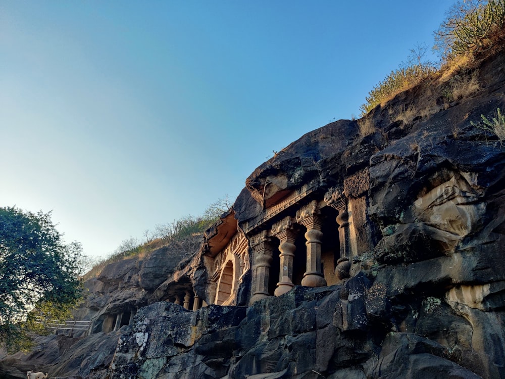 a large rock formation with many columns on top of it