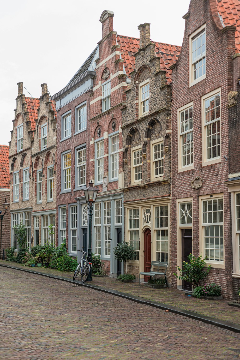 a cobblestone street lined with old brick buildings