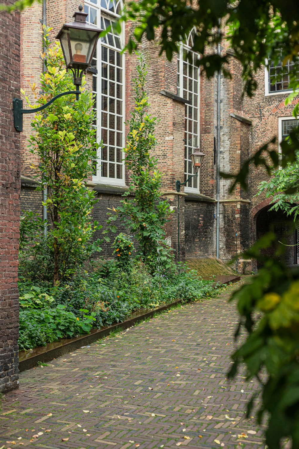 a cobblestone walkway in front of a brick building