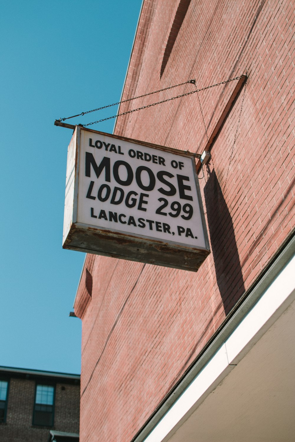 a sign hanging from the side of a building