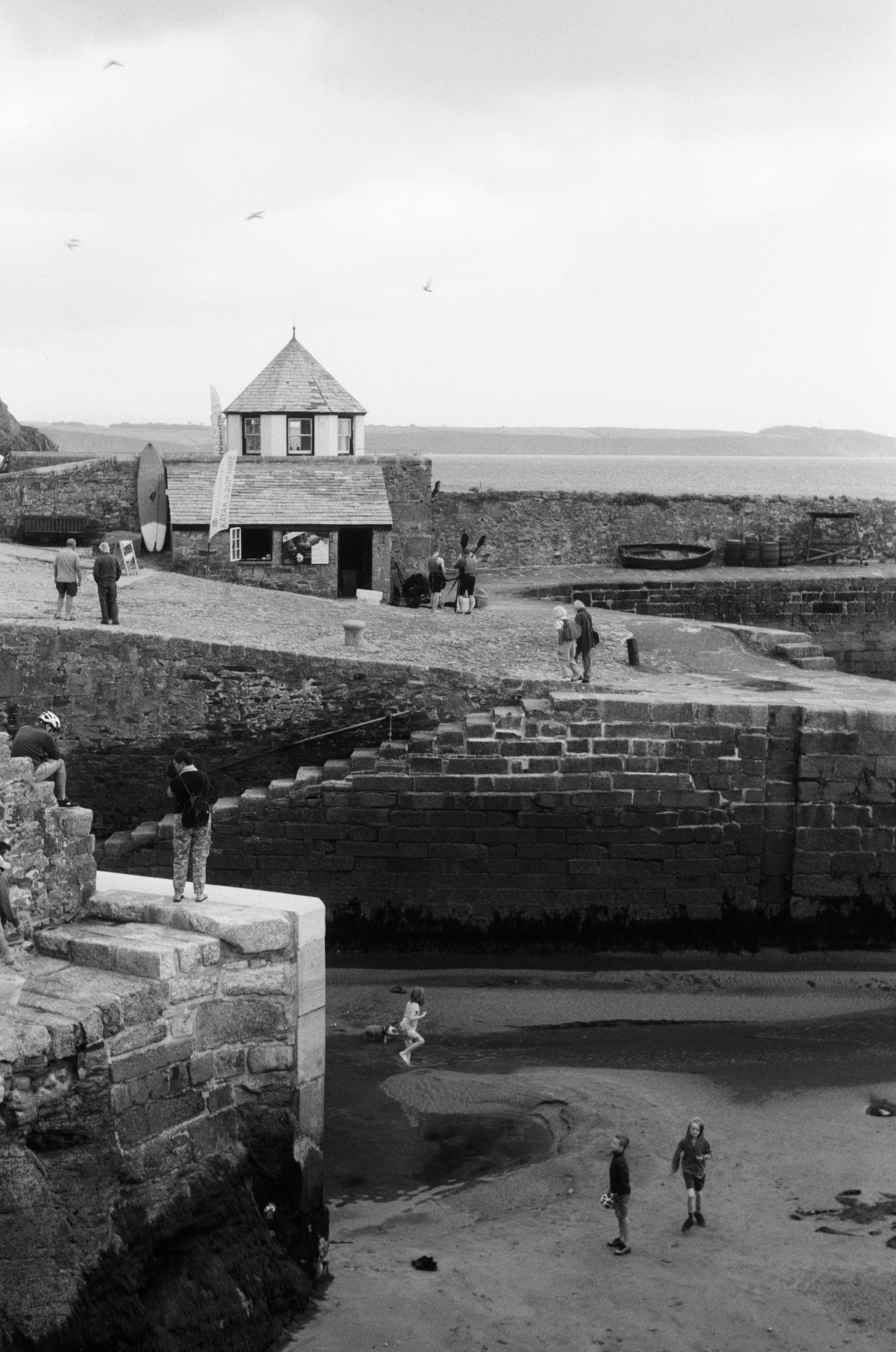 a black and white photo of people on a beach