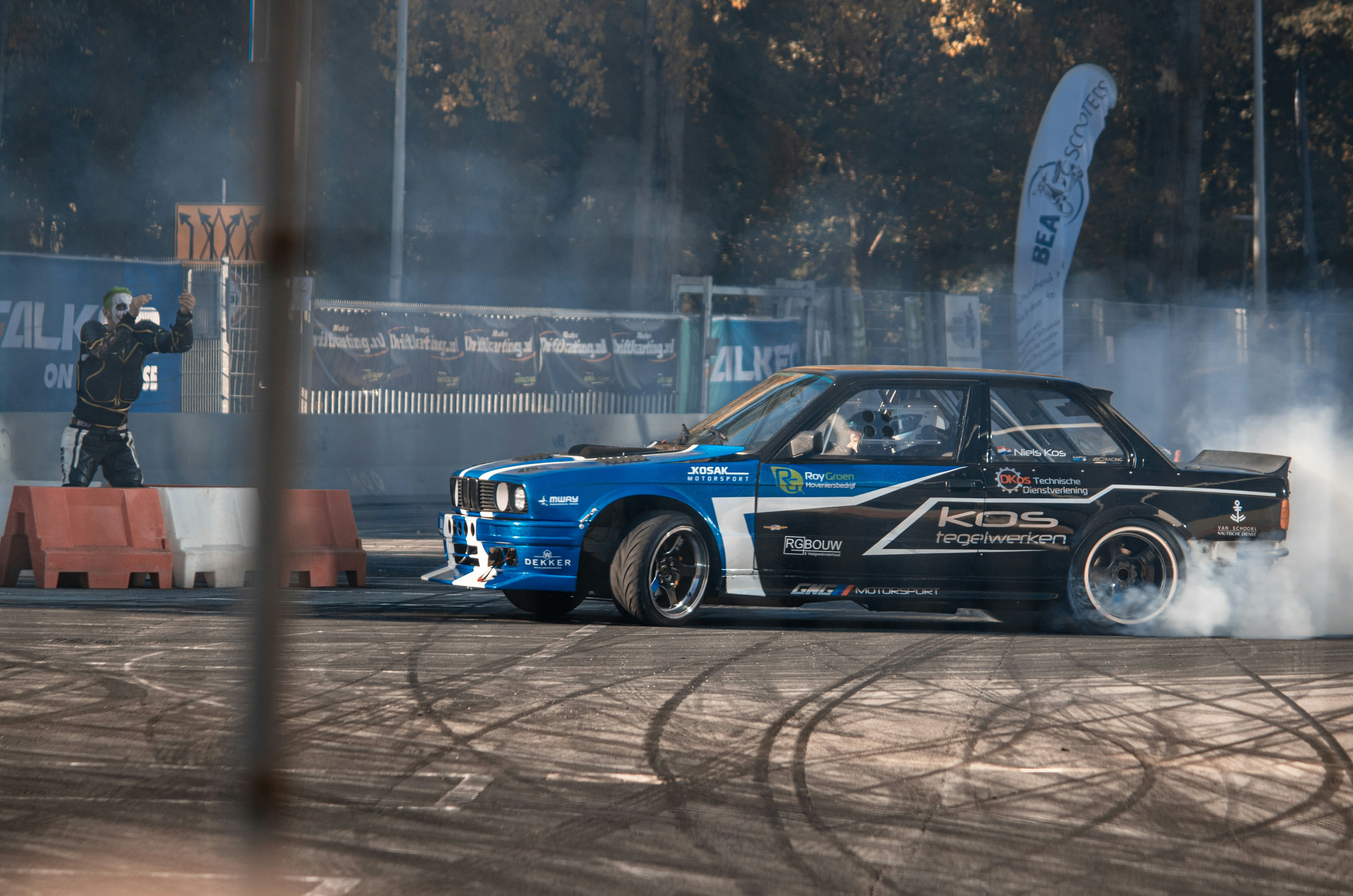 a blue car with smoke coming out of it