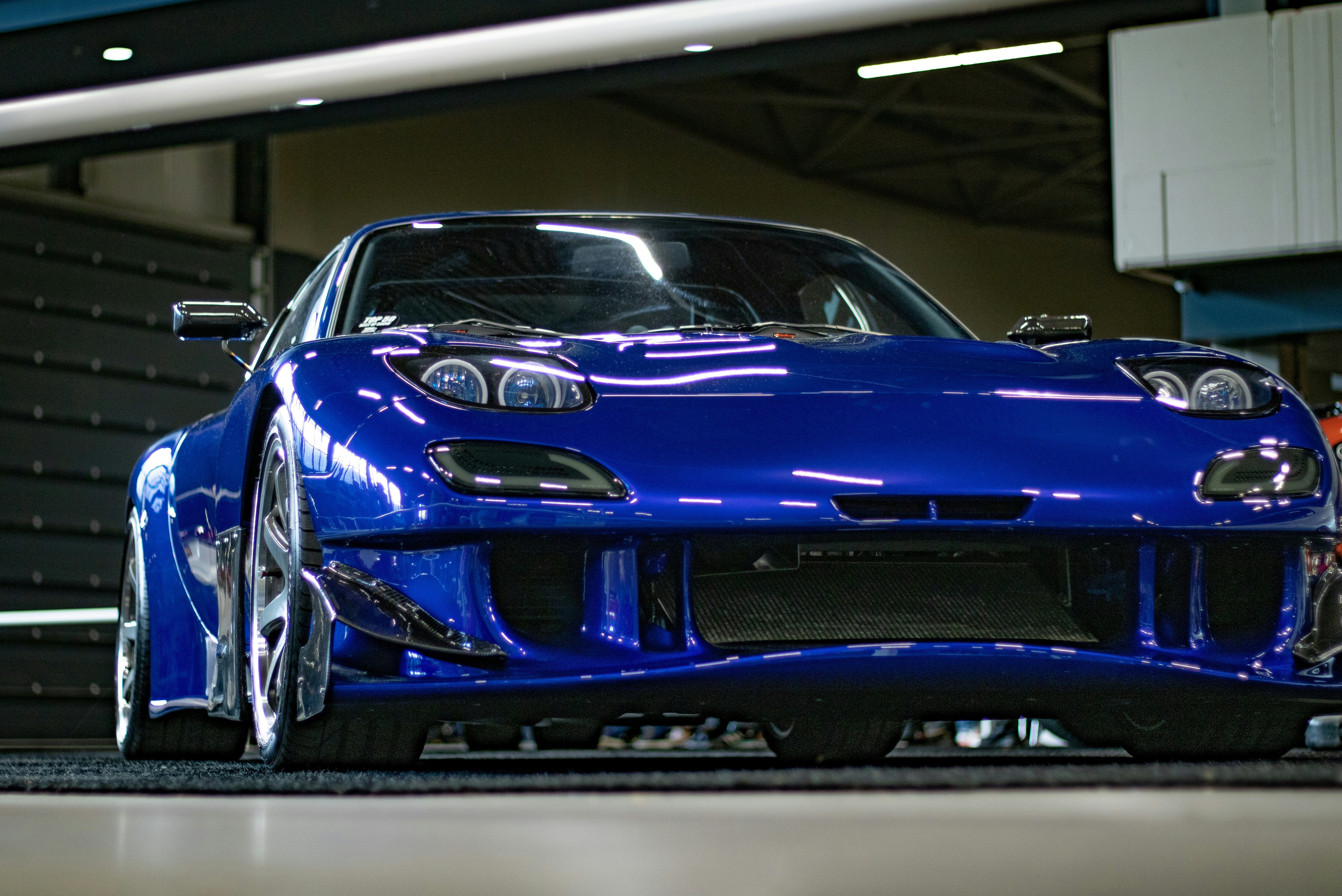a blue sports car parked in a garage
