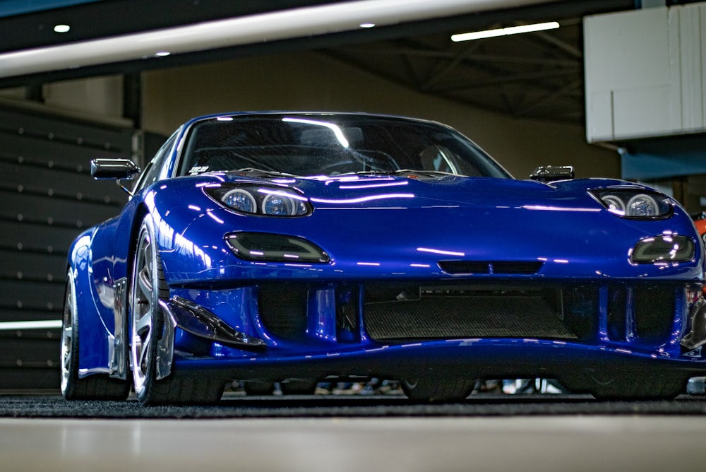 a blue sports car parked in a garage