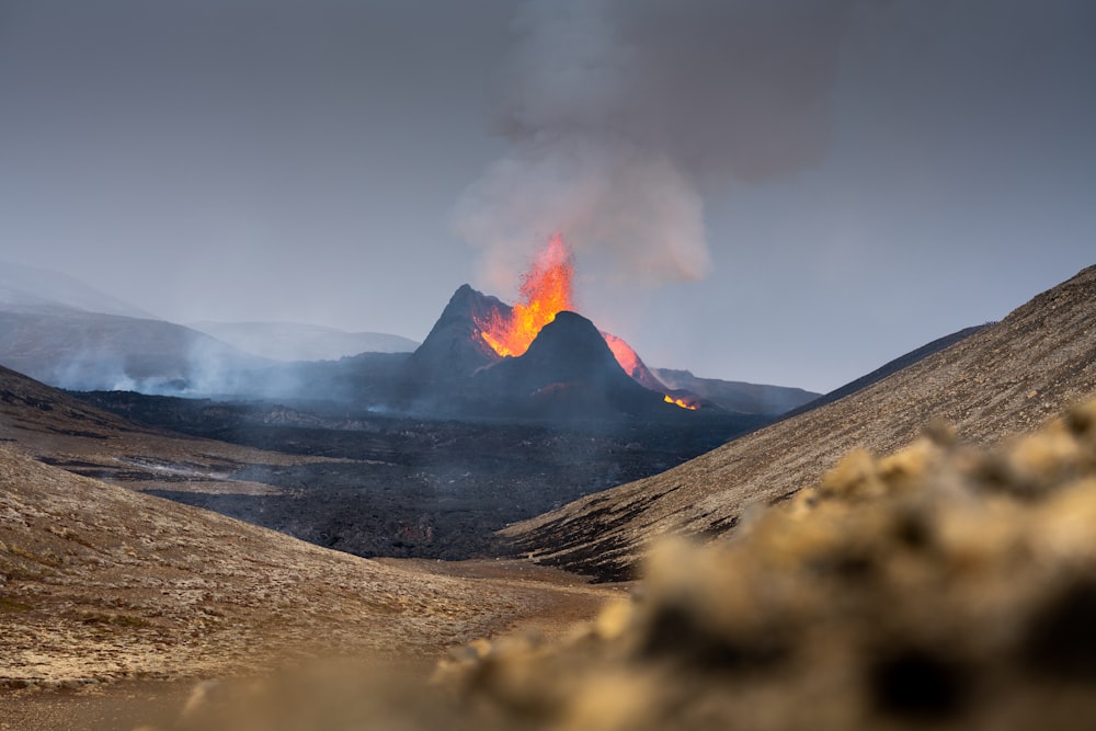 a volcano spewing out lava in the distance