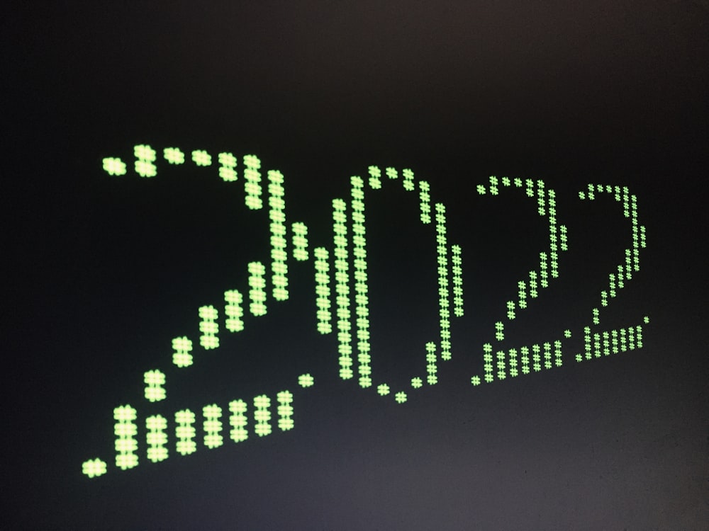 a close up of a clock with green numbers on it