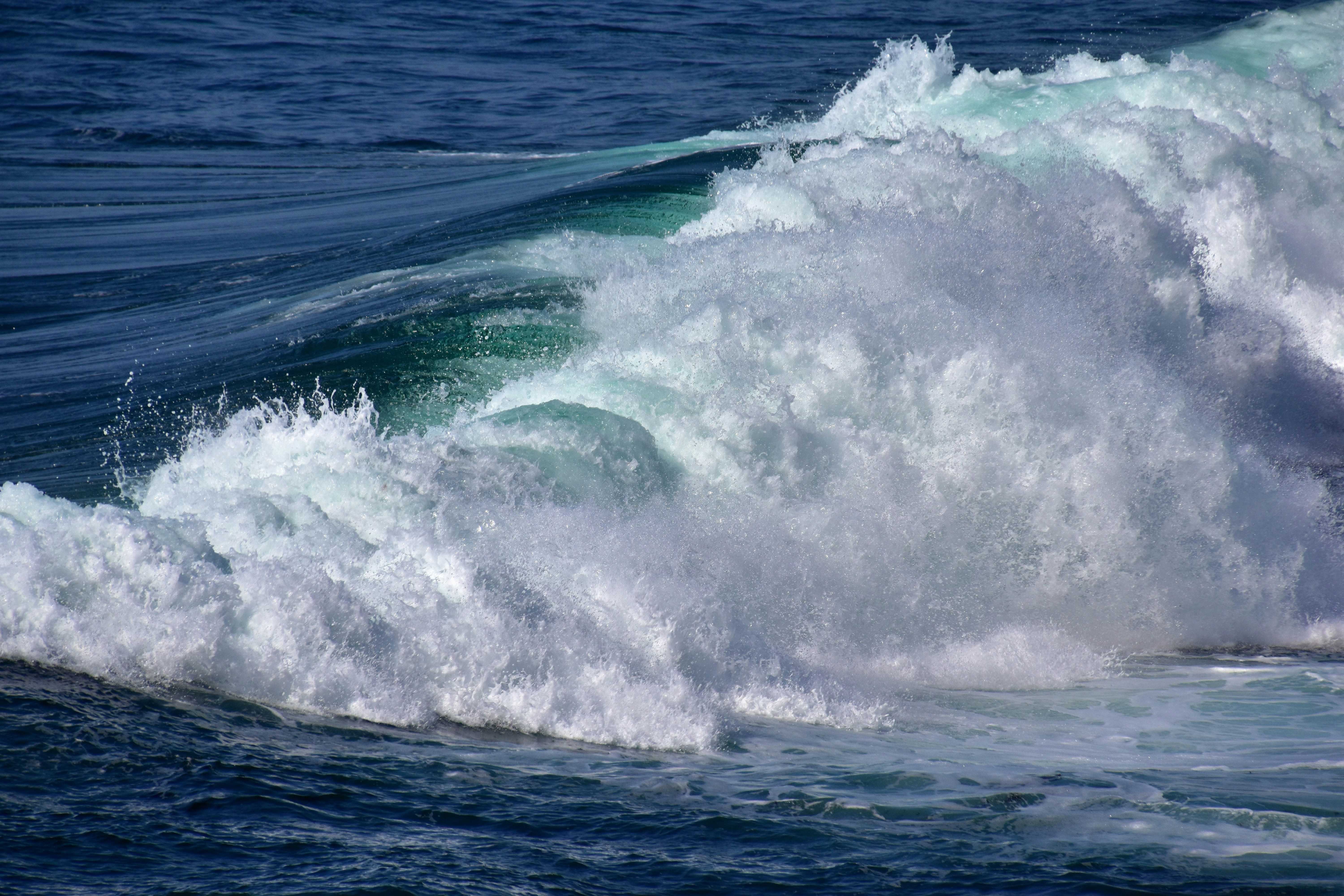 a man riding a wave on top of a surfboard