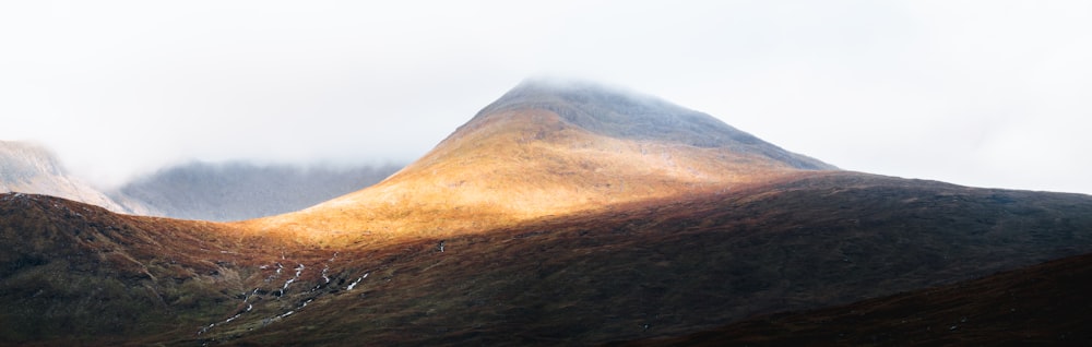 a view of a mountain in the clouds