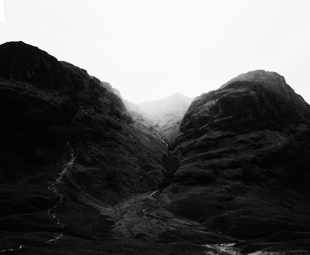 a black and white photo of a mountain range