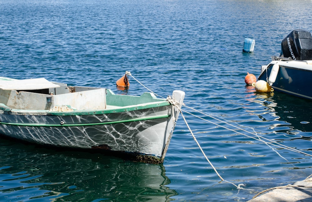 a boat tied to a dock in the water