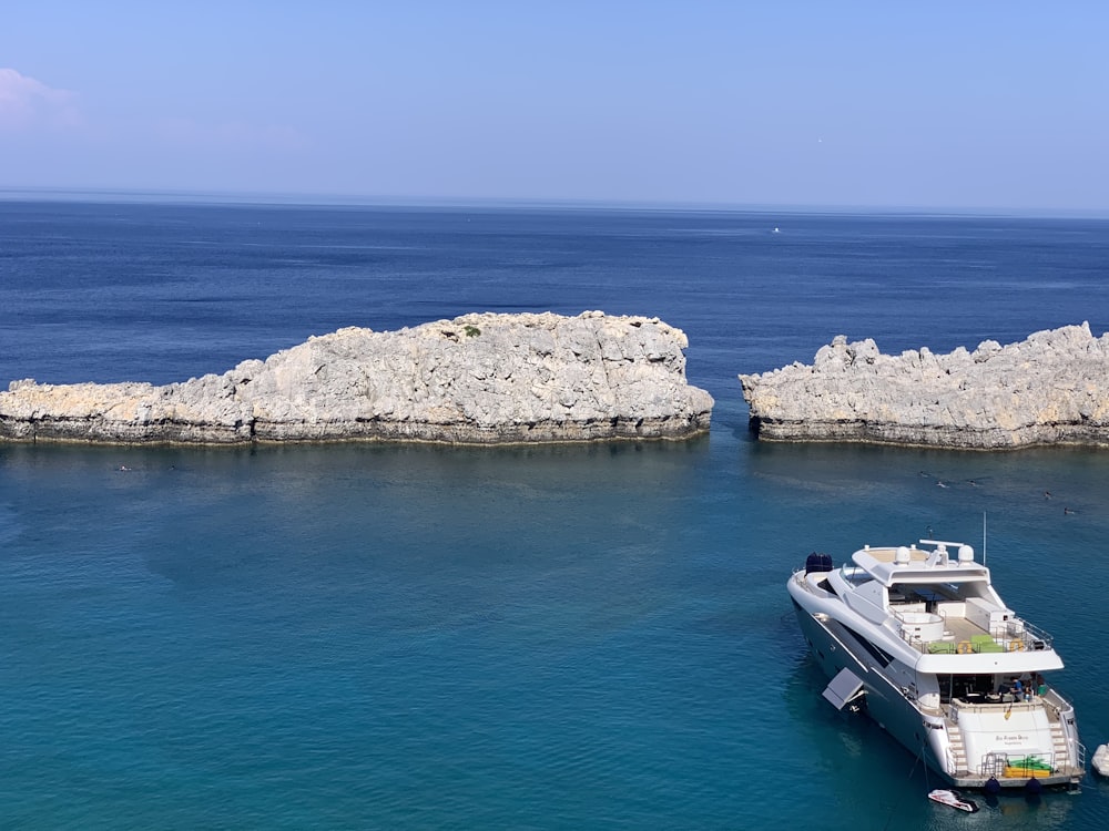 a white boat in the middle of a body of water