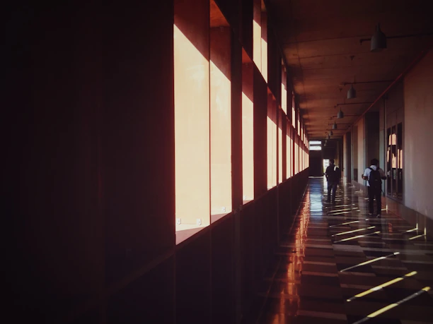 a long hallway with people walking down it