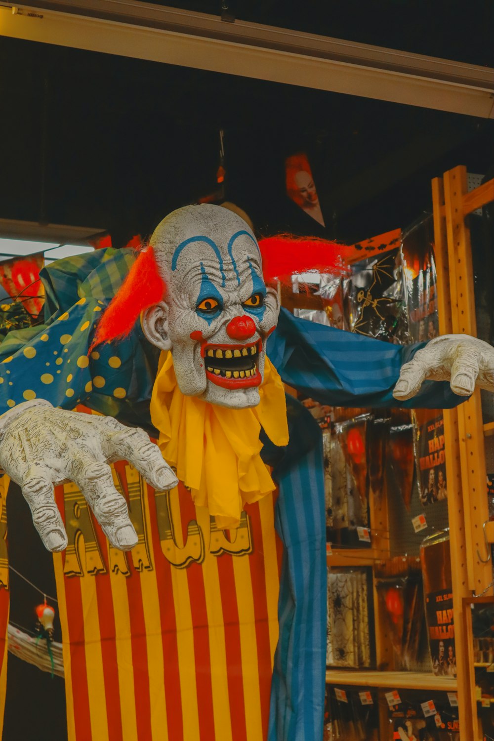 a creepy clown holding a chair in a store