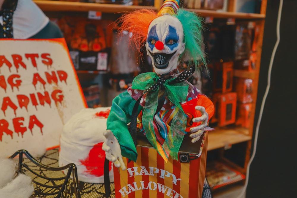 a creepy clown is holding a box of candy
