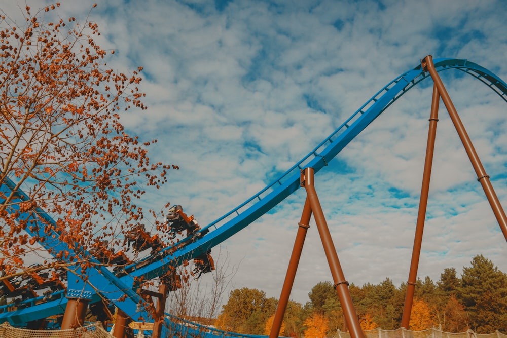 a blue roller coaster going down a hill