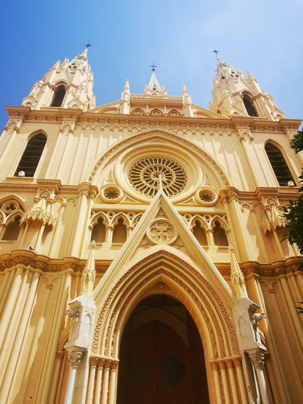 a very tall cathedral with a clock on it's side