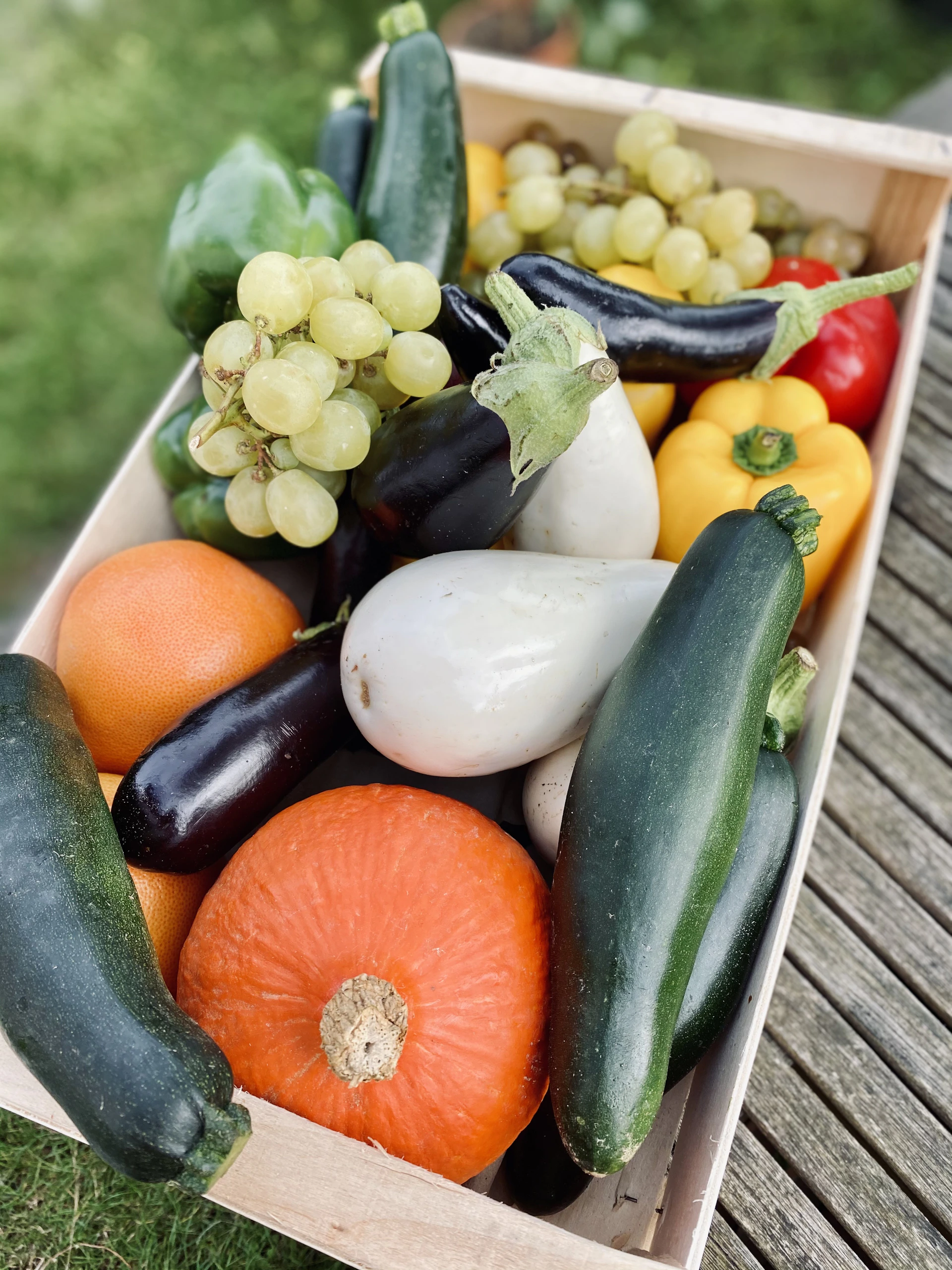 a wooden crate filled with lots of different types of vegetables