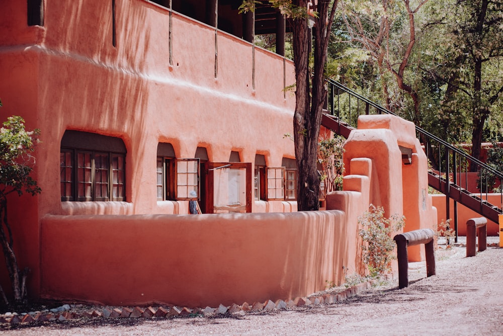 a red building with windows and a staircase leading up to it