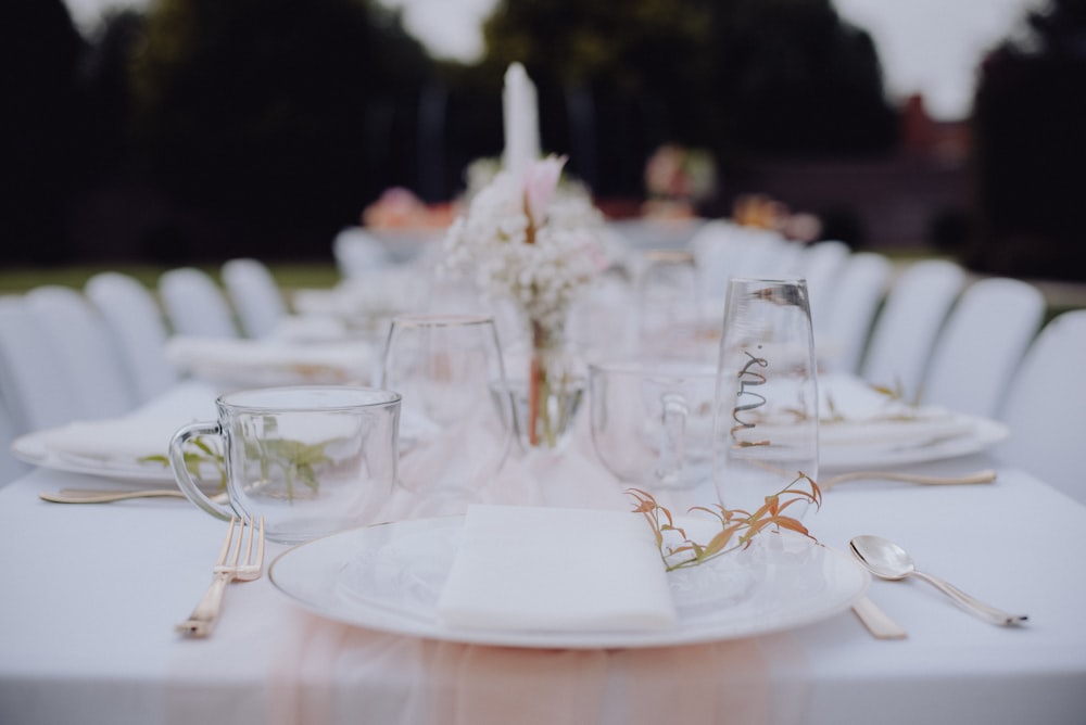 a table set for a formal dinner outside