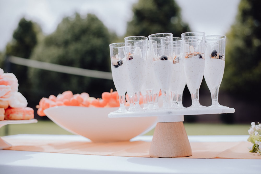 a table topped with lots of glasses of champagne