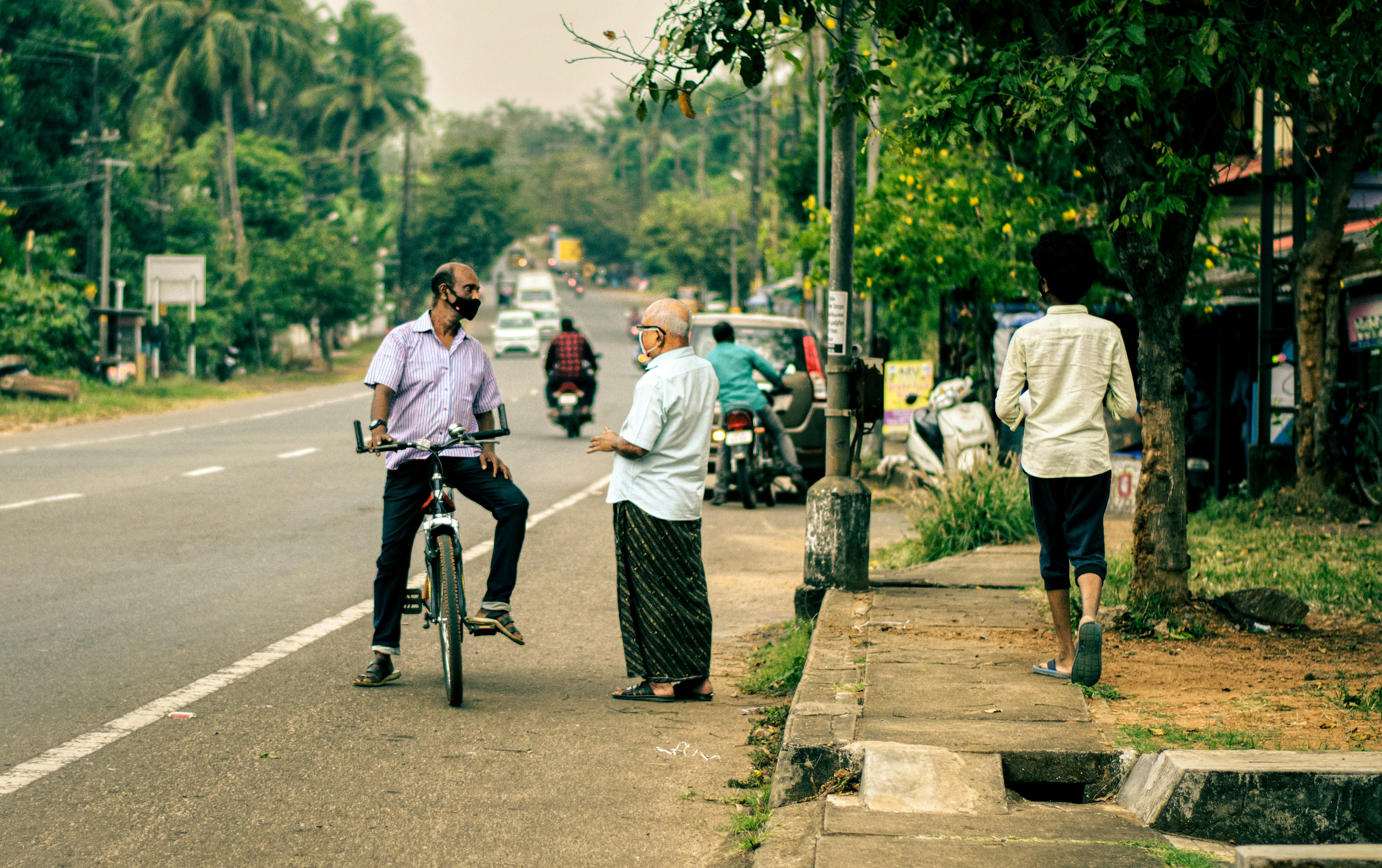 a man riding a bike down a street next to a woman