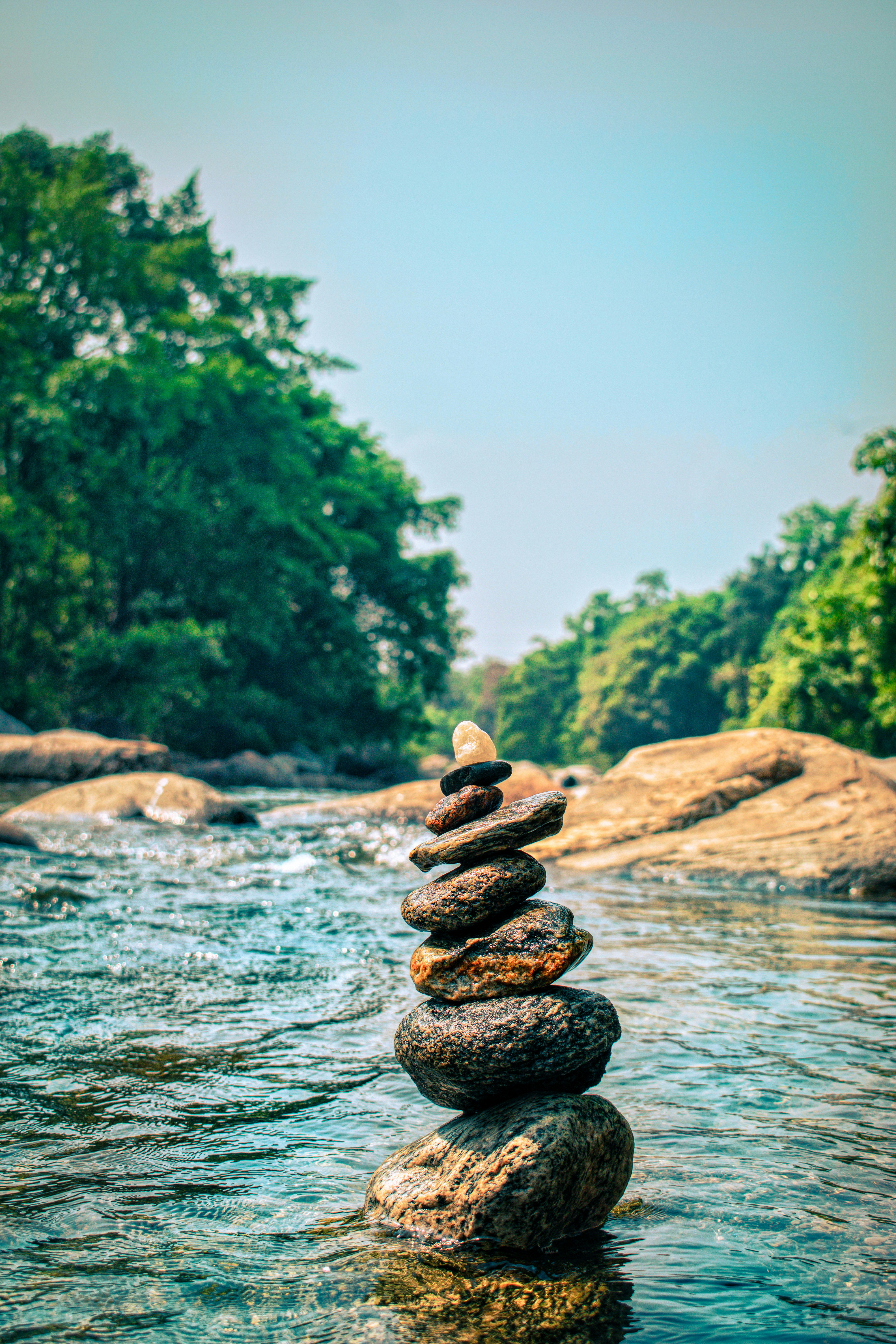a stack of rocks sitting on top of a river