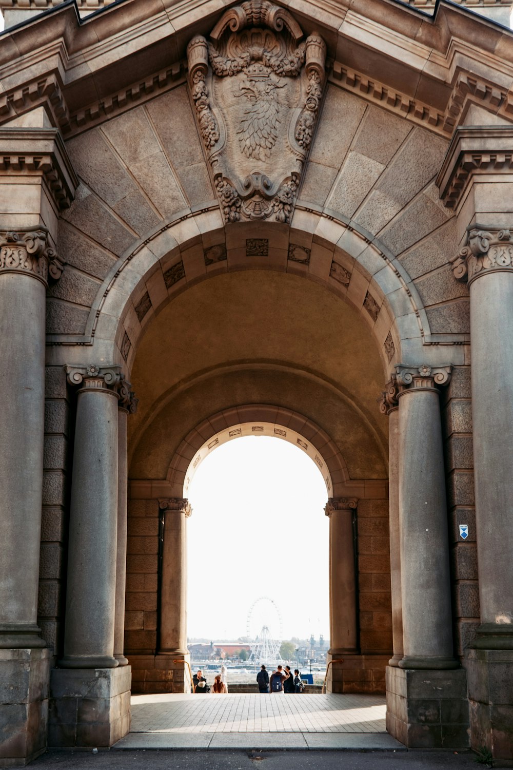 a stone archway with a clock on the top of it