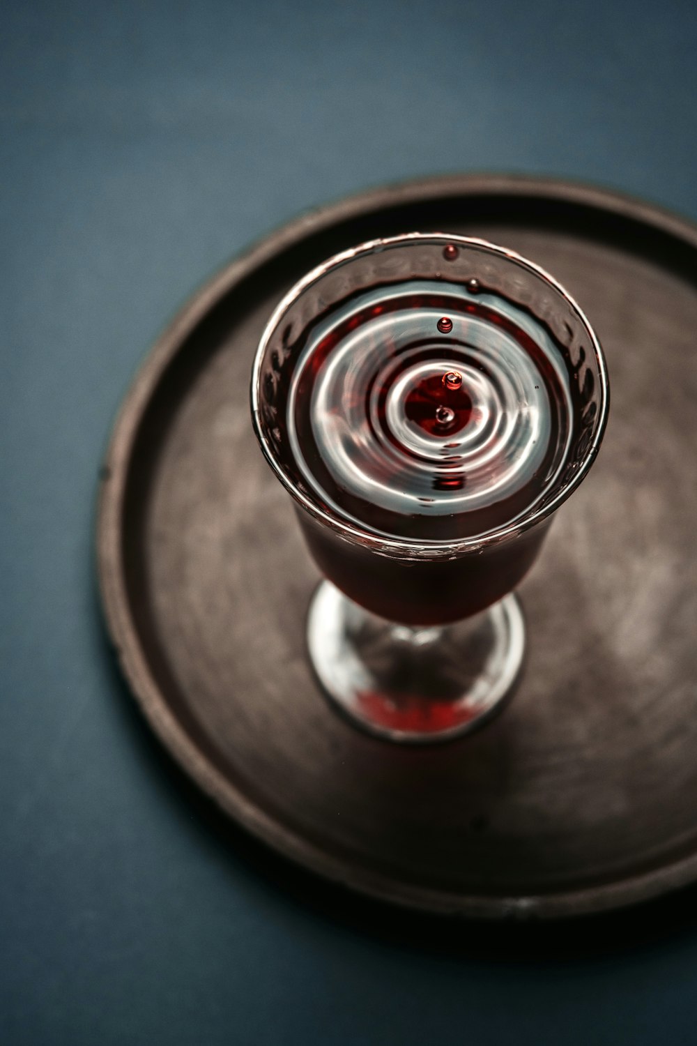 a wine glass sitting on top of a metal tray