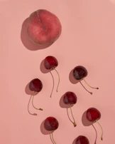 A variety of fruit-shaped squishy toys arranged on a pastel background