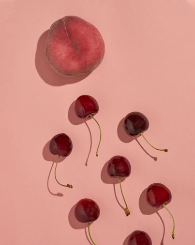 Close-up of colorful fruit-shaped squishy toys arranged on a pastel background