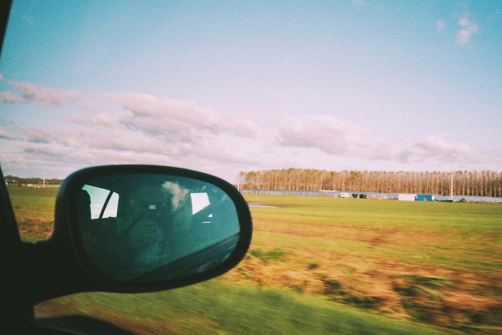 a view of a field from a car window