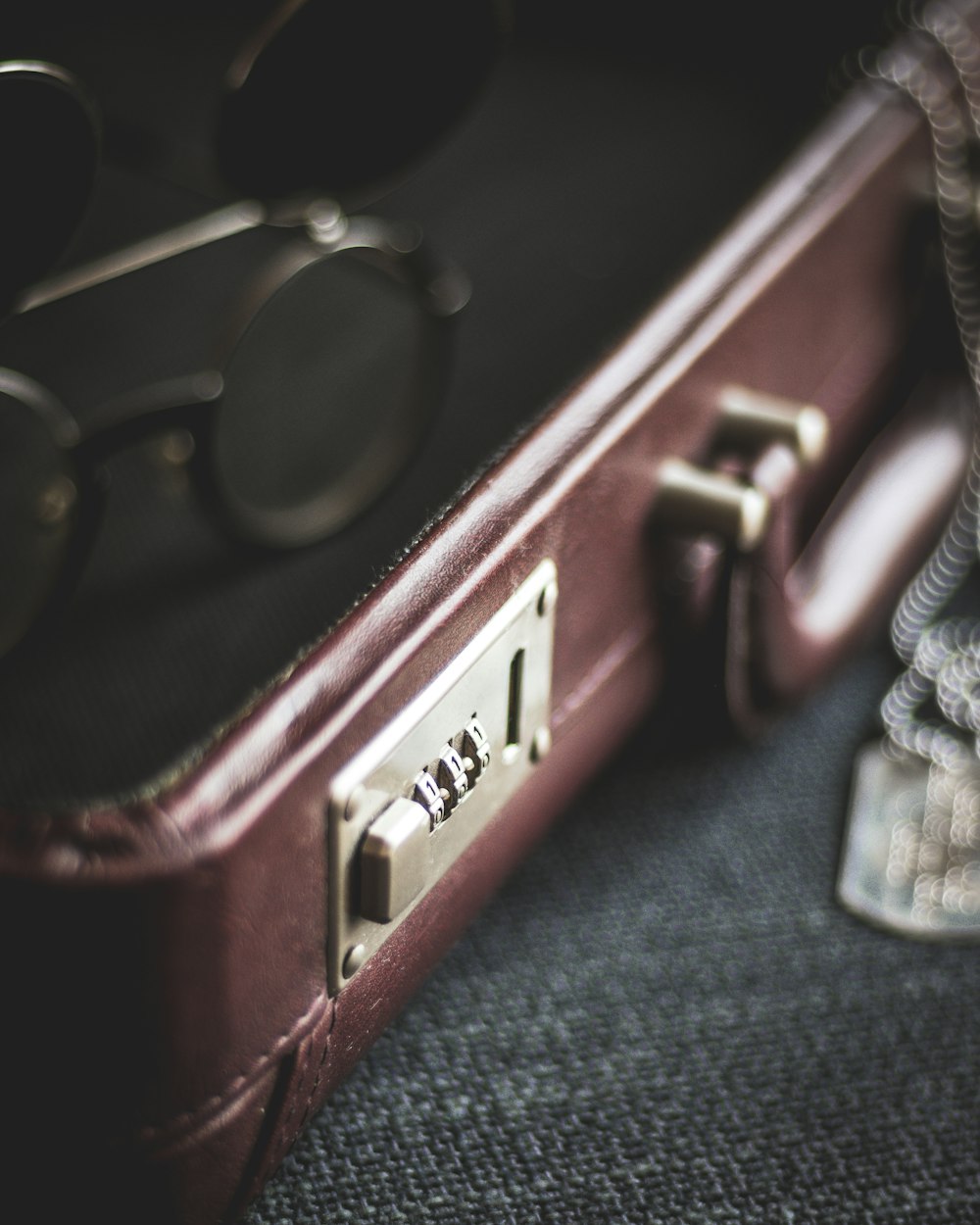 a piece of brown luggage sitting on top of a floor