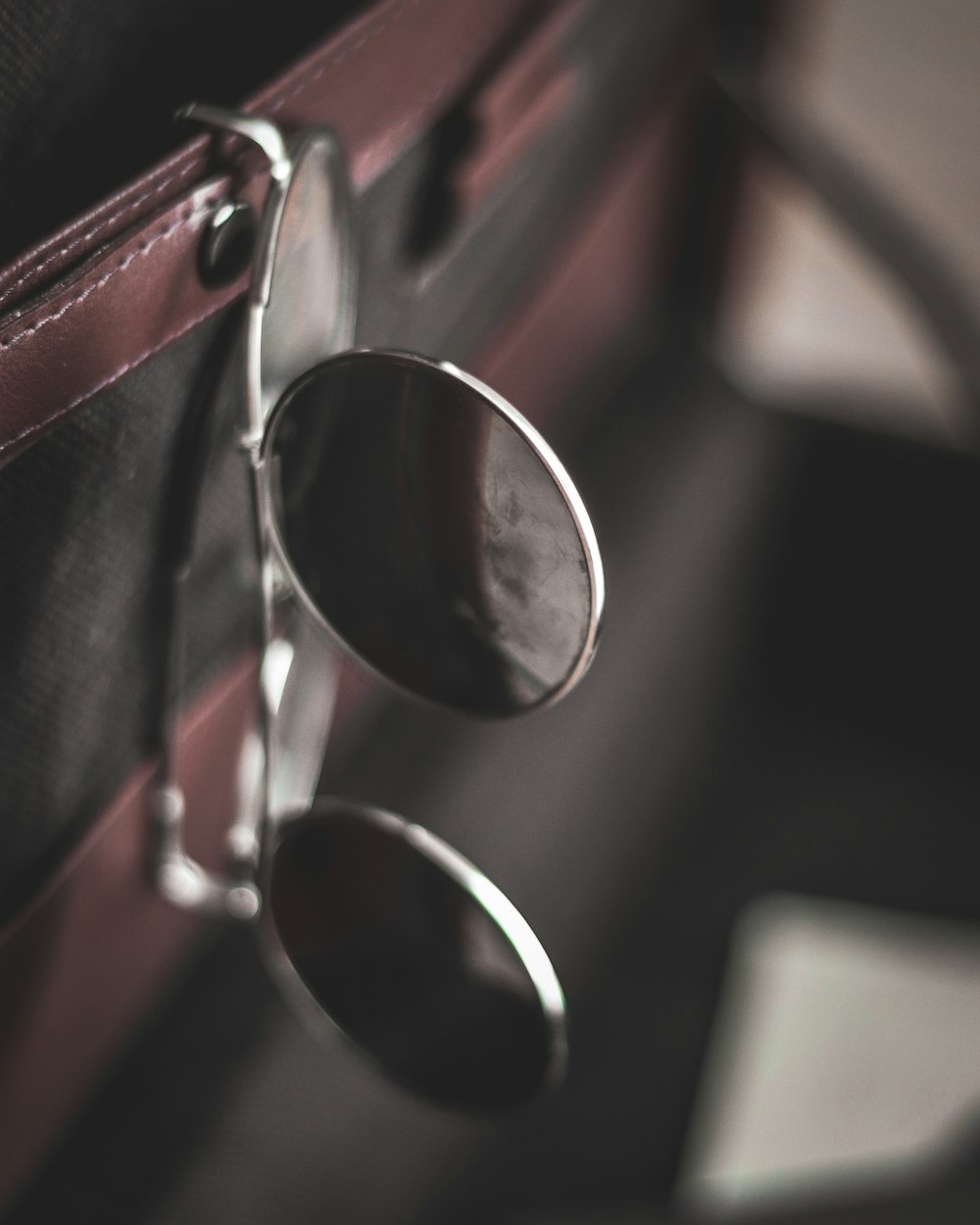 a pair of sunglasses sitting on top of a piece of luggage