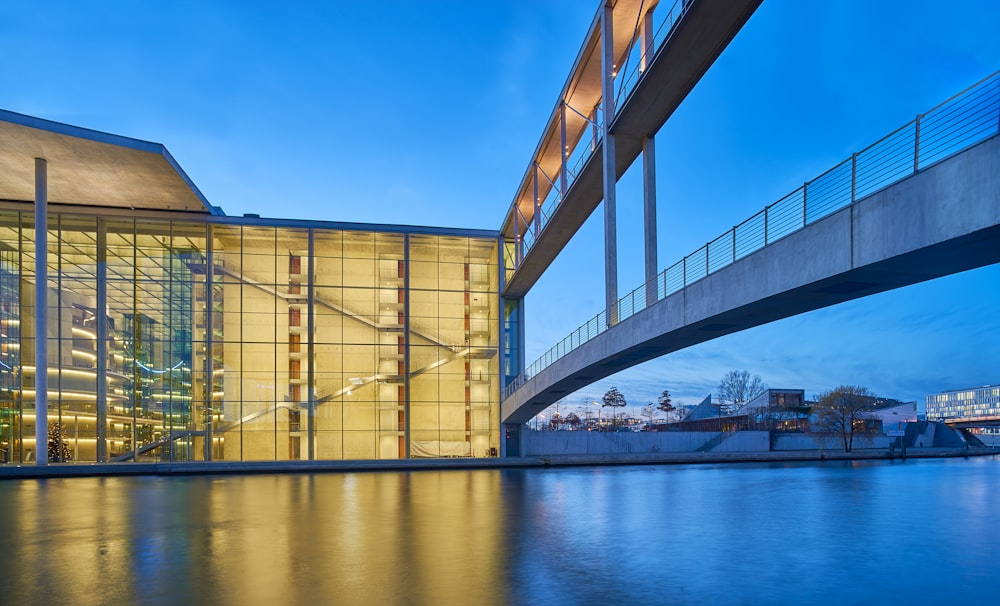 a bridge over a body of water next to a building