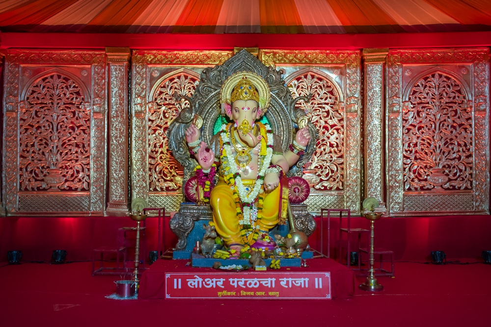 Una estatua de un dios hindú frente a un escenario