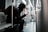 a person sitting on a bus looking at a cell phone