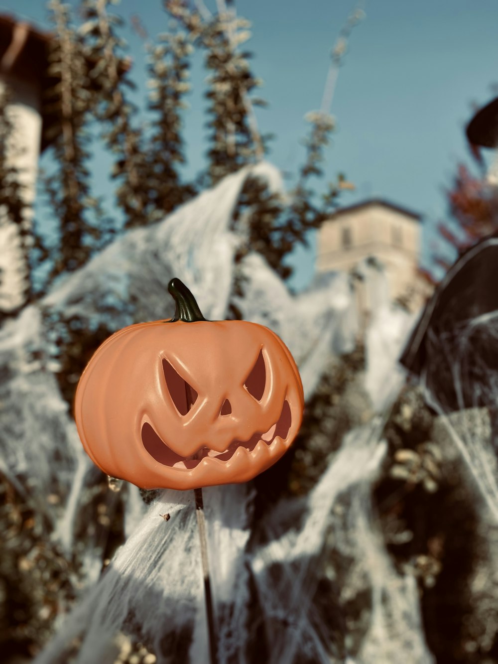 a carved pumpkin sitting on top of a stick