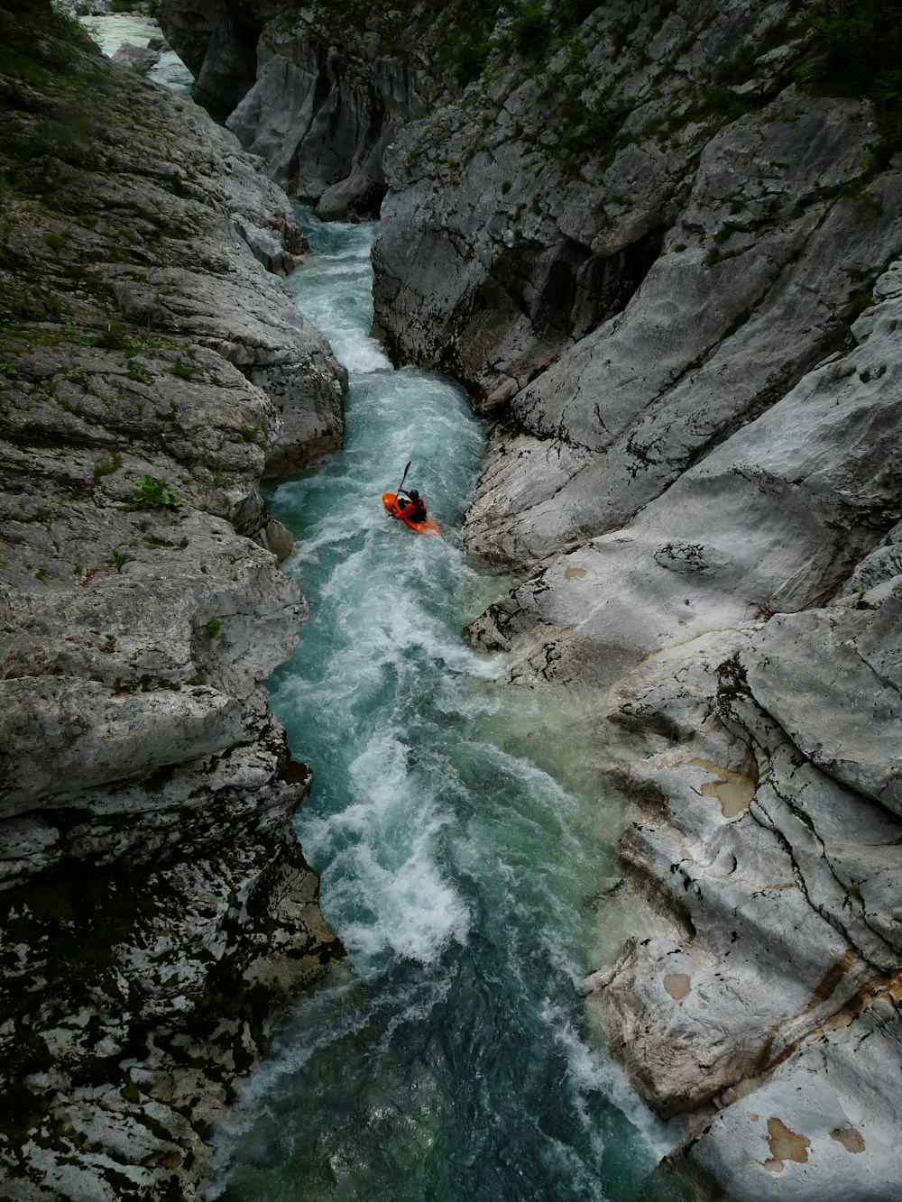 a person in a kayak in the middle of a river