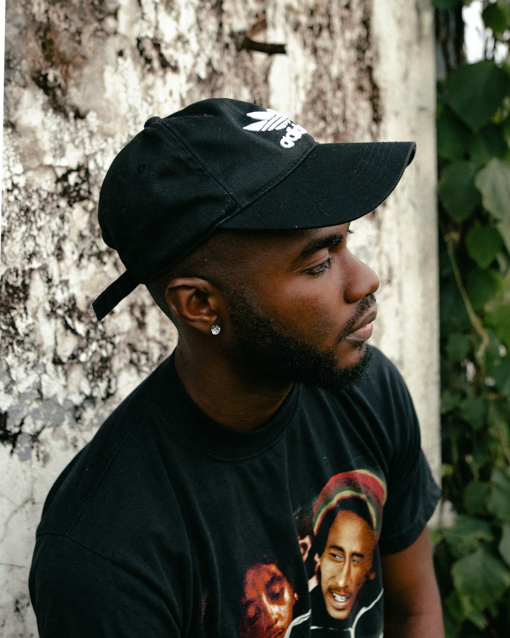 a man wearing a black hat and a black shirt