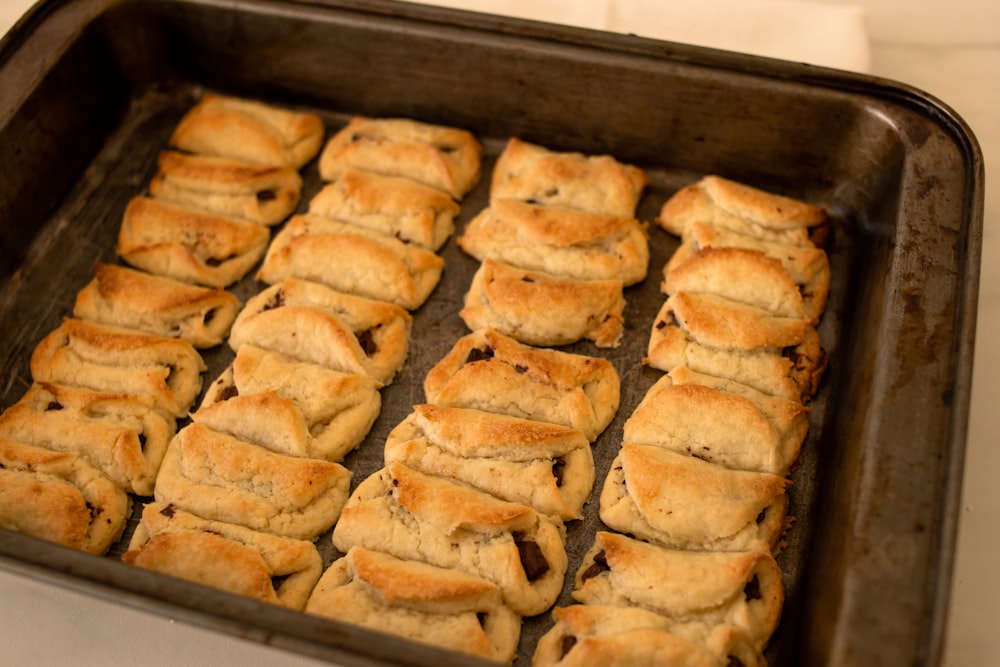 a pan filled with lots of food on top of a table