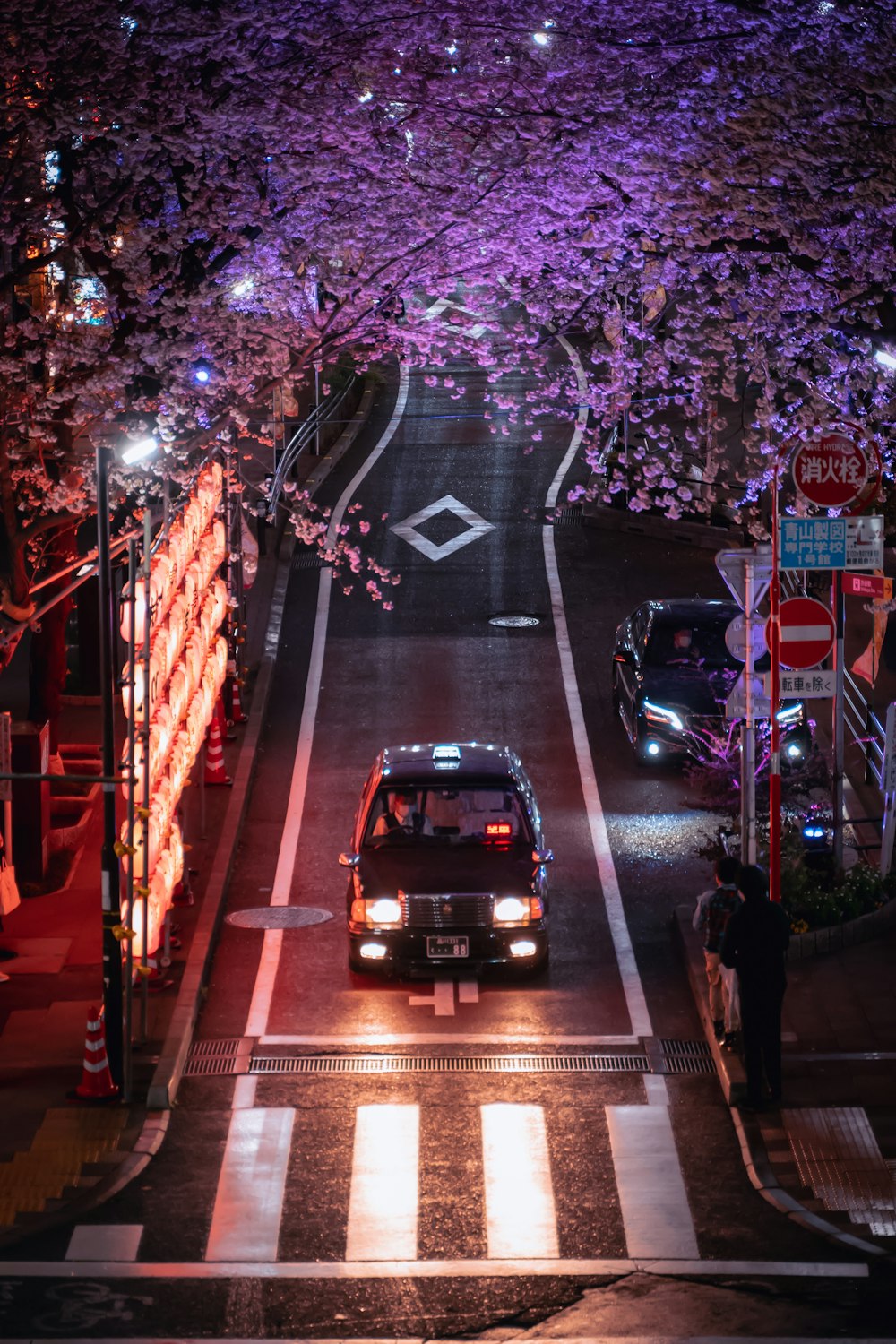 a car driving down a street at night