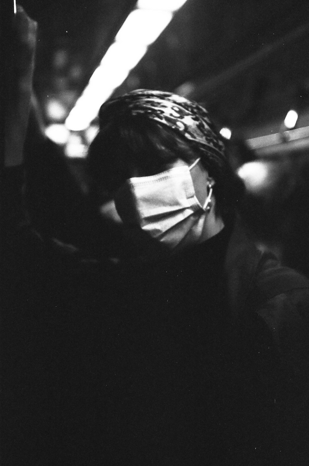 a woman wearing a face mask in the dark